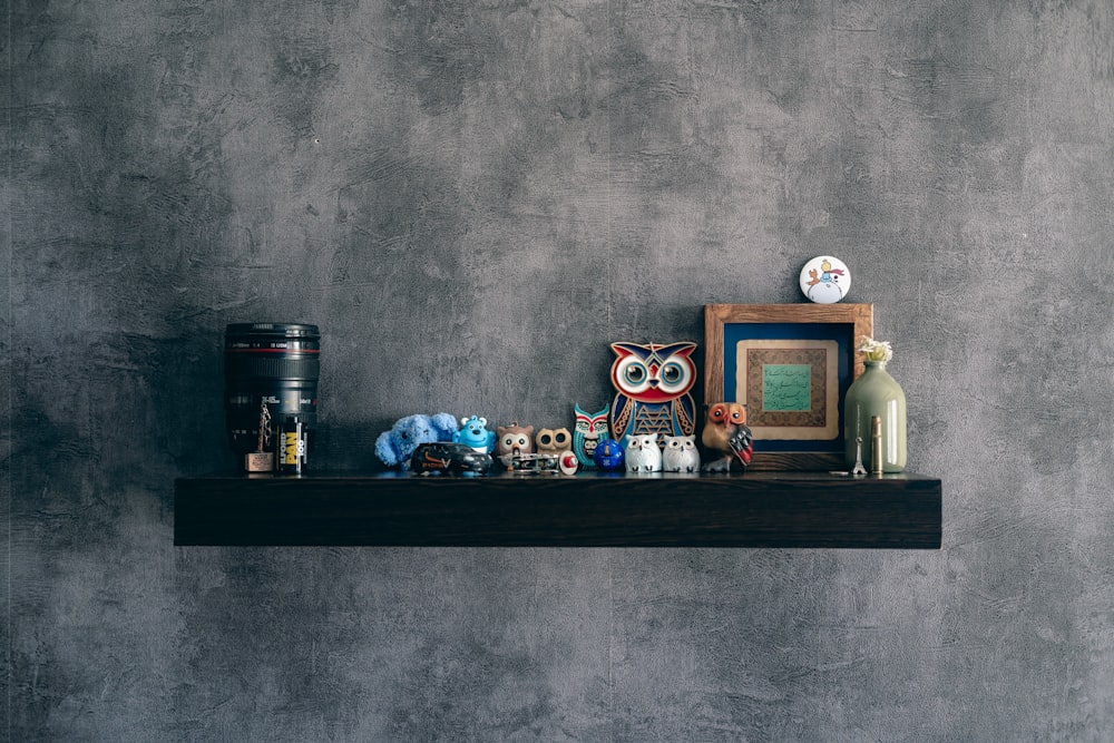 a shelf with a picture, a picture frame, and other items on it