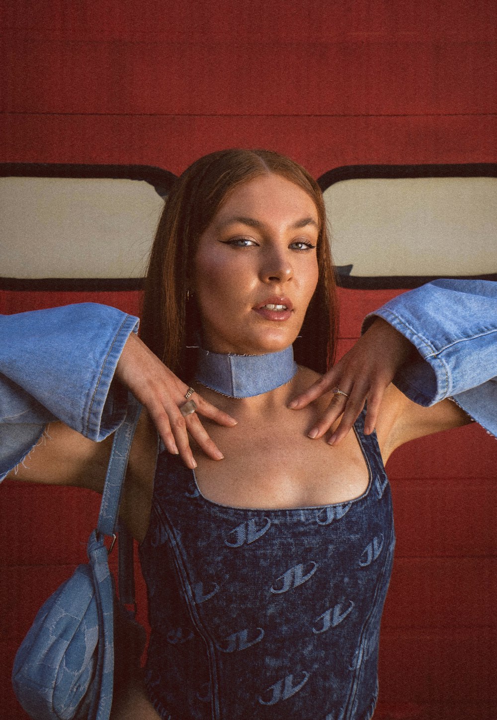 a woman in a denim outfit with her hands on her hips