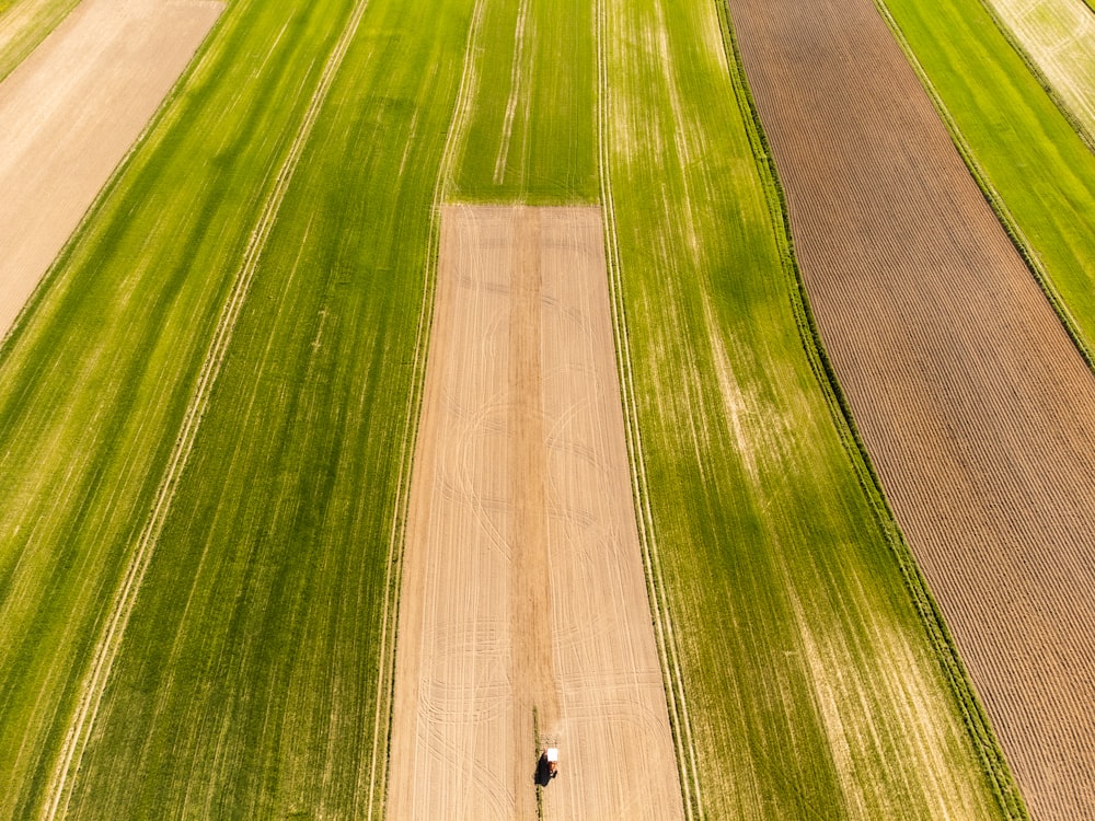 an aerial view of a field with a tractor in the middle of it