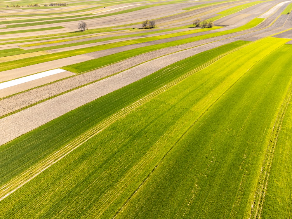 an aerial view of a large field of green grass