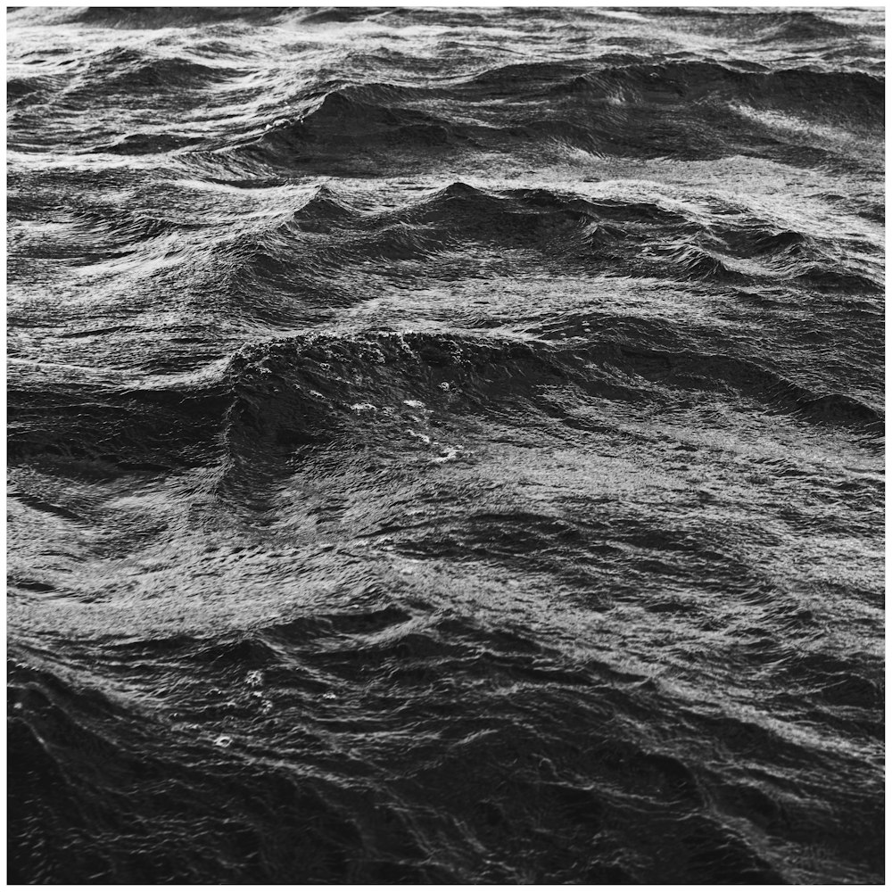 a black and white photo of waves in the ocean