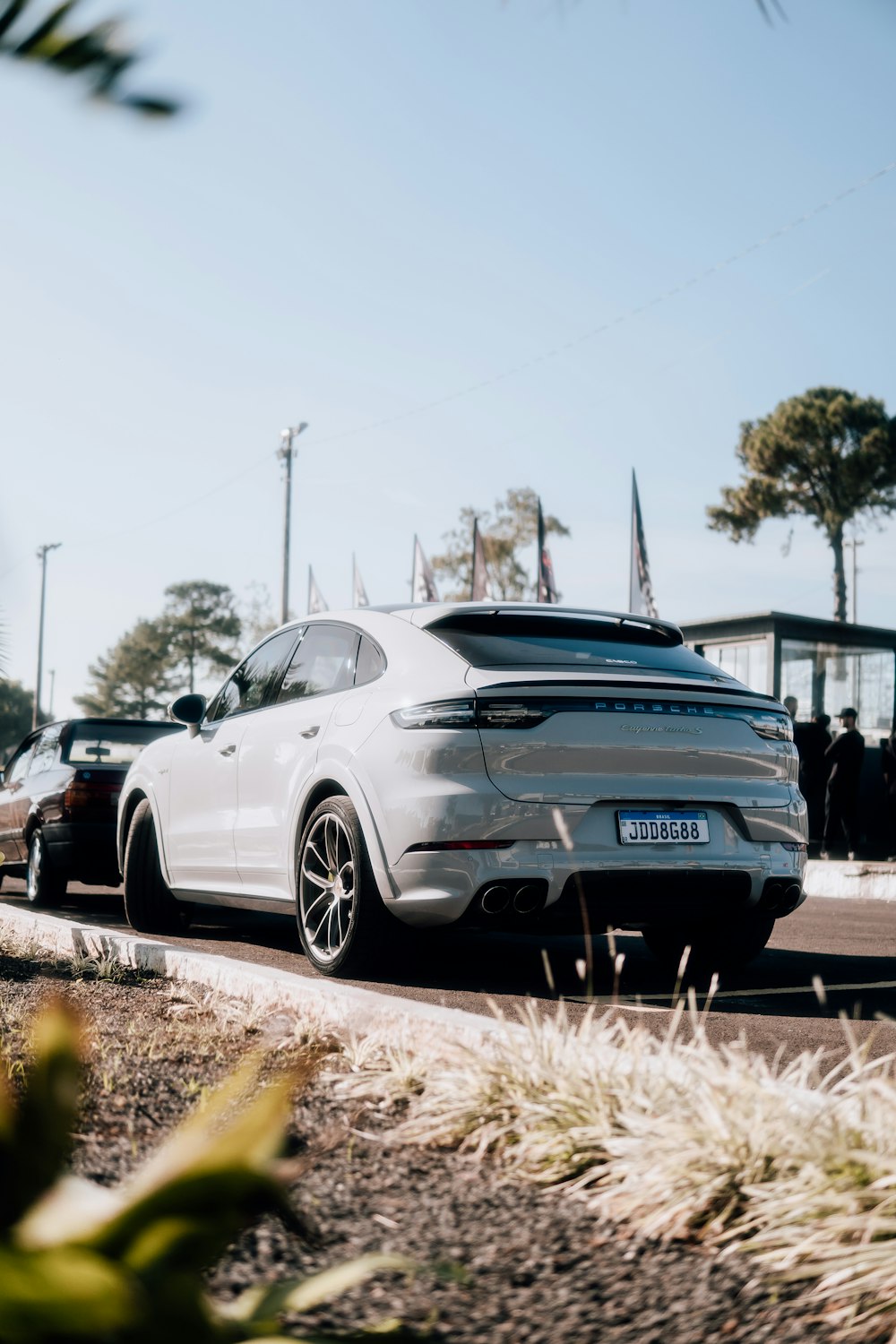 a white car is parked on the side of the road