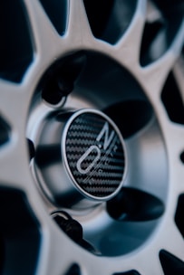 Close-up of a vibrant red centre cap snapped onto a VW wheel.