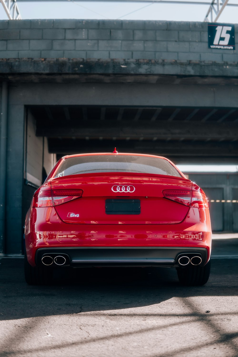 a red car parked in front of a building