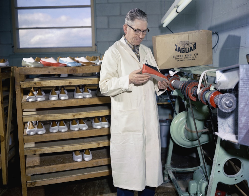 a man in a lab coat looking at a piece of paper