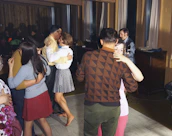 A romantic couple dancing closely with the band playing softly in the background.