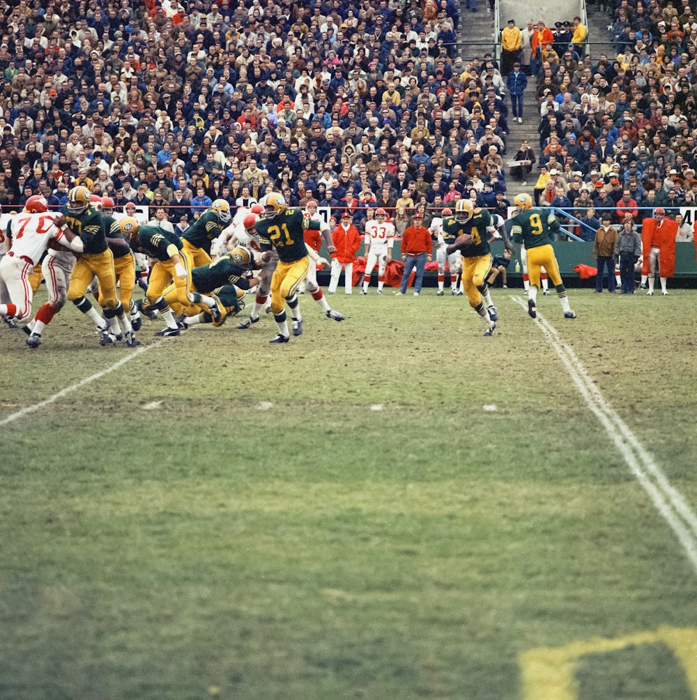 a group of football players playing a game of football