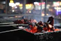 A close-up shot of sizzling meat grilling over glowing mangal coals, with wisps of smoke curling into the evening air.