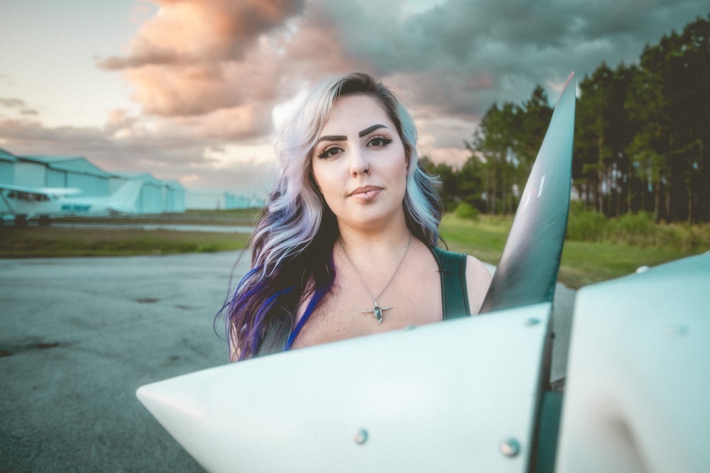 a woman with blue hair holding a knife