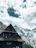 Outdoor view of a traditional Swiss chalet restaurant nestled in snowy alpine scenery.