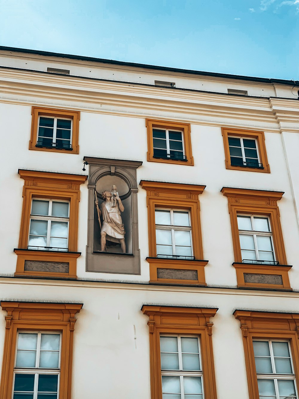 a building with a statue on the side of it