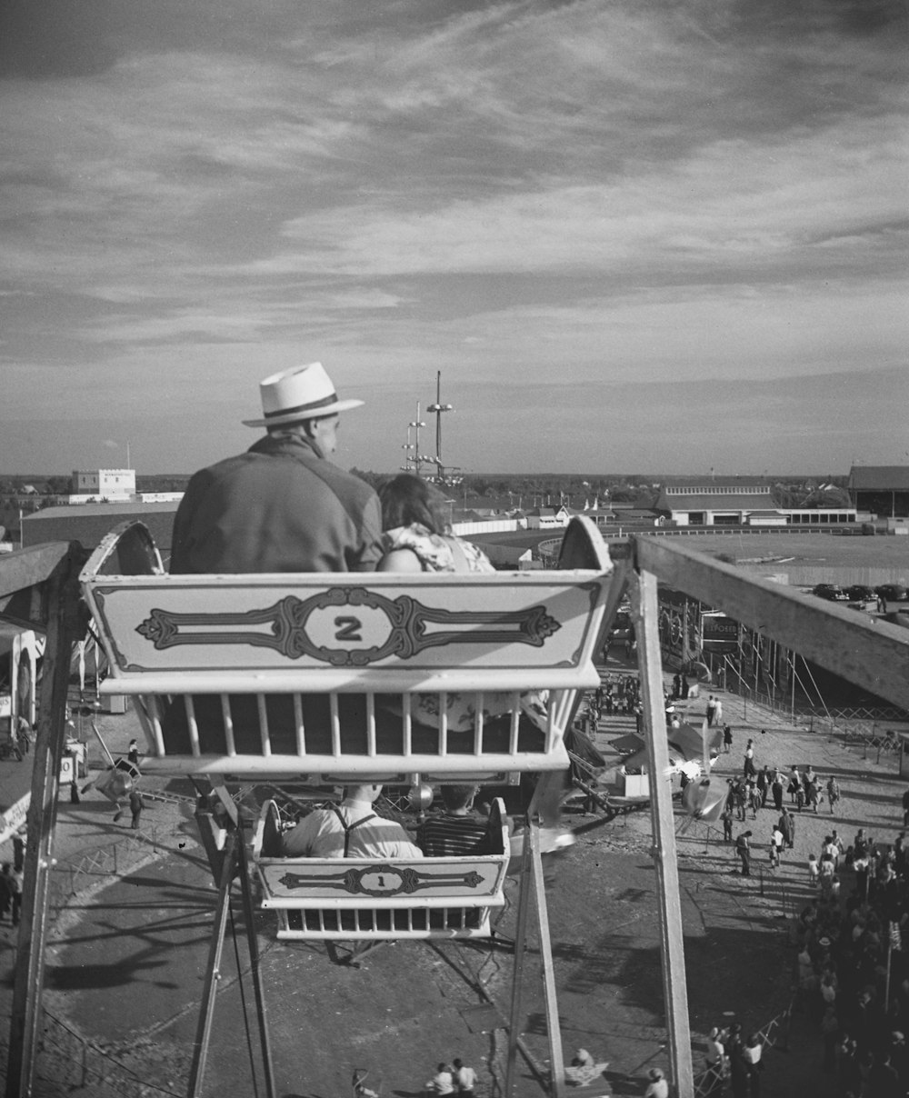 a black and white photo of a man and a child in a boat