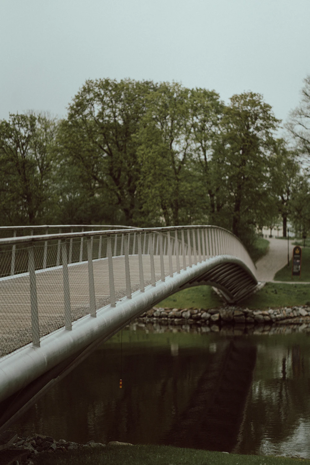 Modern steel footbridge over water, reference photo