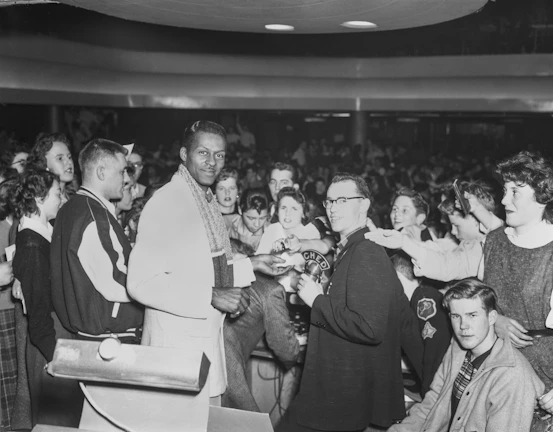 An author signing copies of his book at a well-attended event.