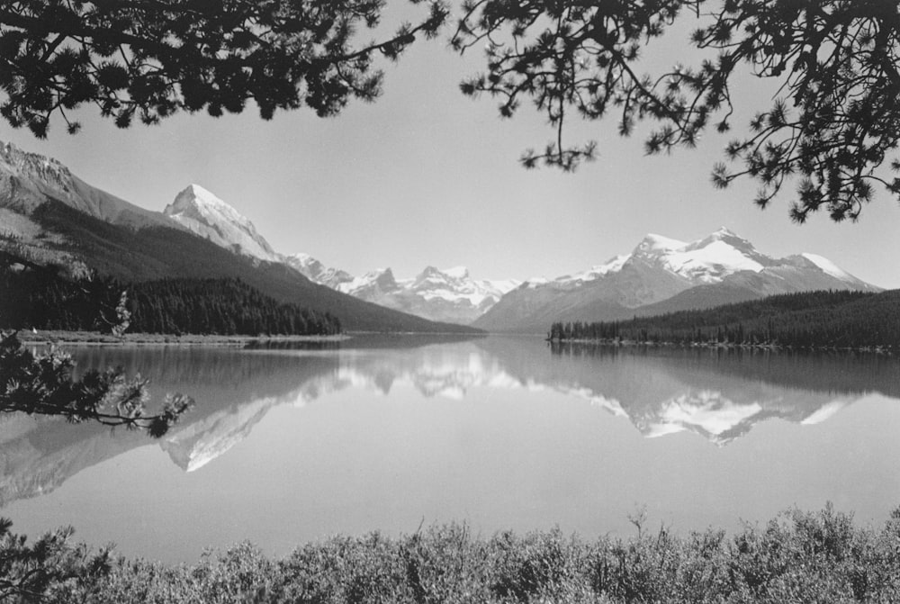 a black and white photo of a mountain lake