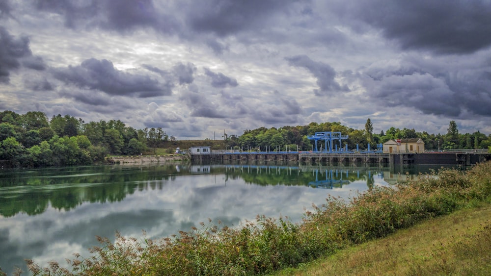 a large body of water with a bridge in the background