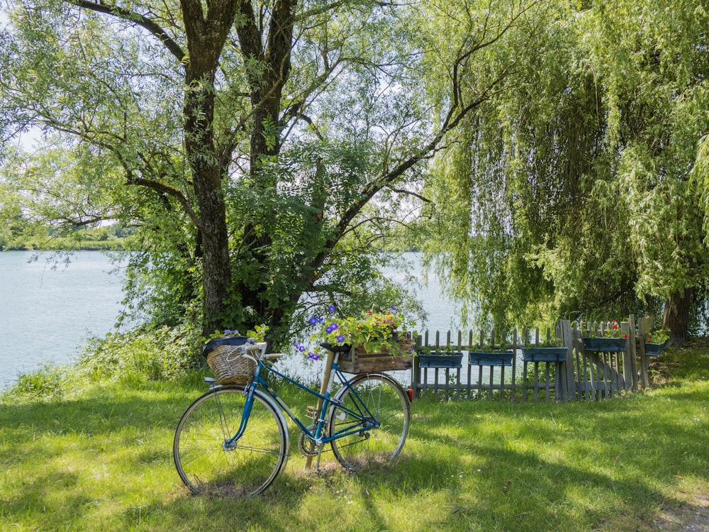 a blue bicycle parked next to a lake