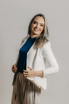 Active US woman tossing a jacket over her shoulder, confident after weight loss.