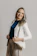 A happy woman wearing stylish women's pants from gayaluna, smiling confidently.