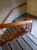 Before and after shot of a staircase showing worn steps transformed to polished timber.