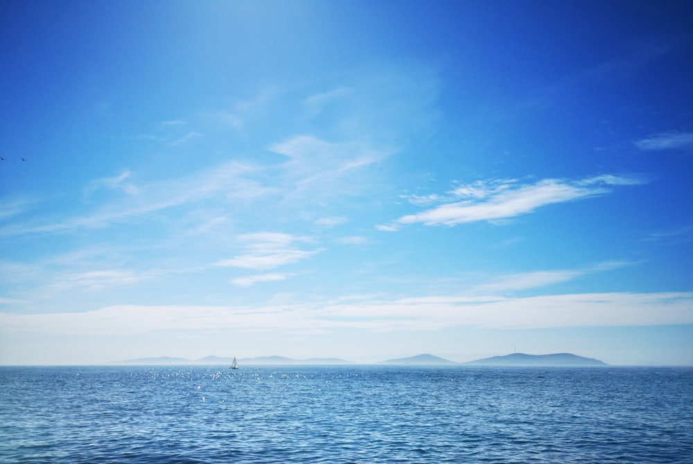 a large body of water under a blue sky