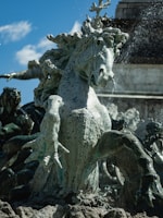 A vibrant sculpture of seven horses in dynamic motion.