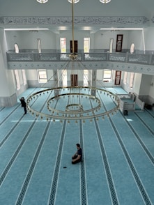 A serene view of Masjid-e-Noorbakshia’s prayer hall bathed in soft natural light highlighting intricate Islamic patterns.