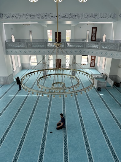 A serene view of Masjid-e-Noorbakshia’s prayer hall bathed in soft natural light highlighting intricate Islamic patterns.