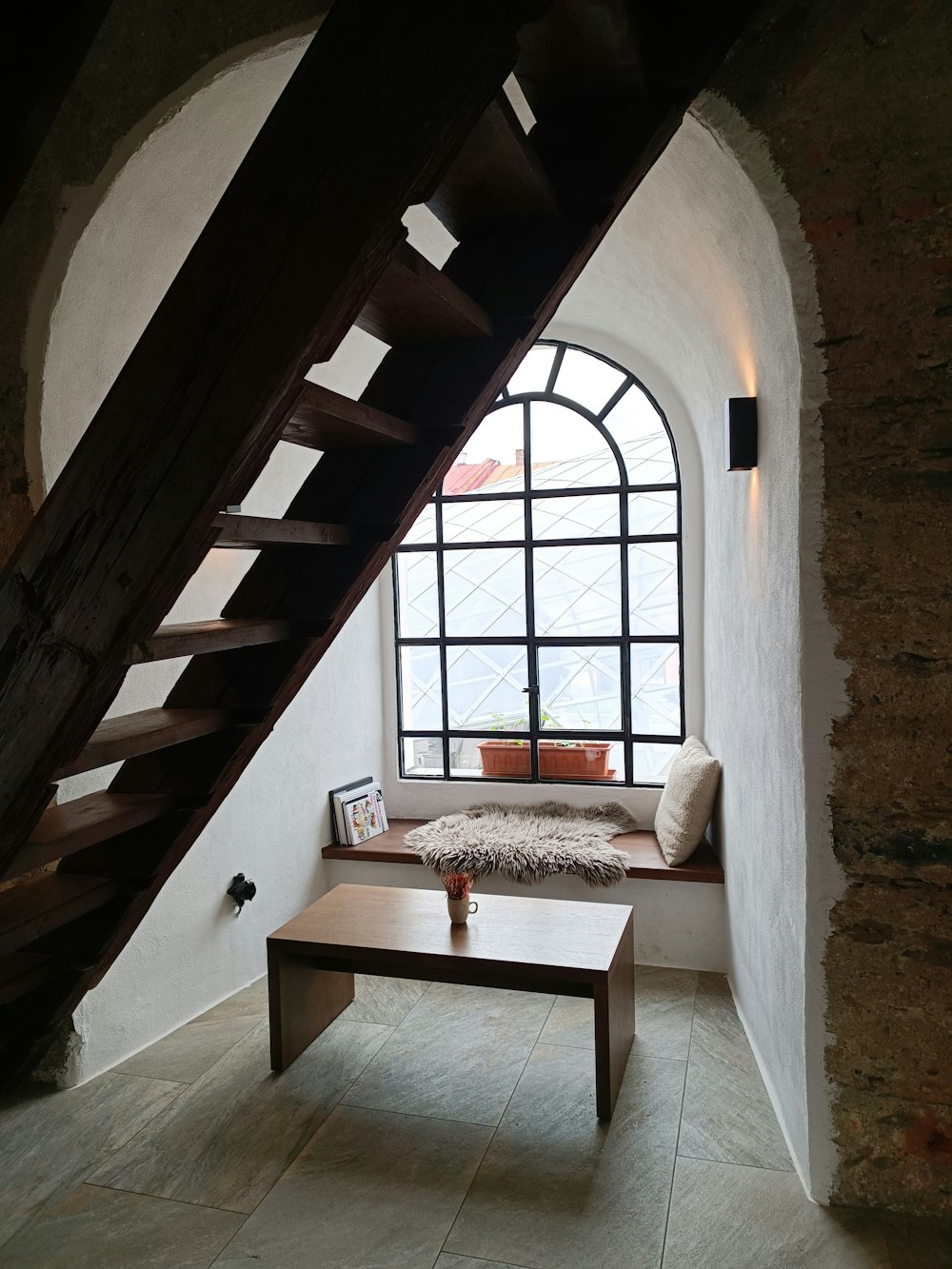 a room with a bench and a window