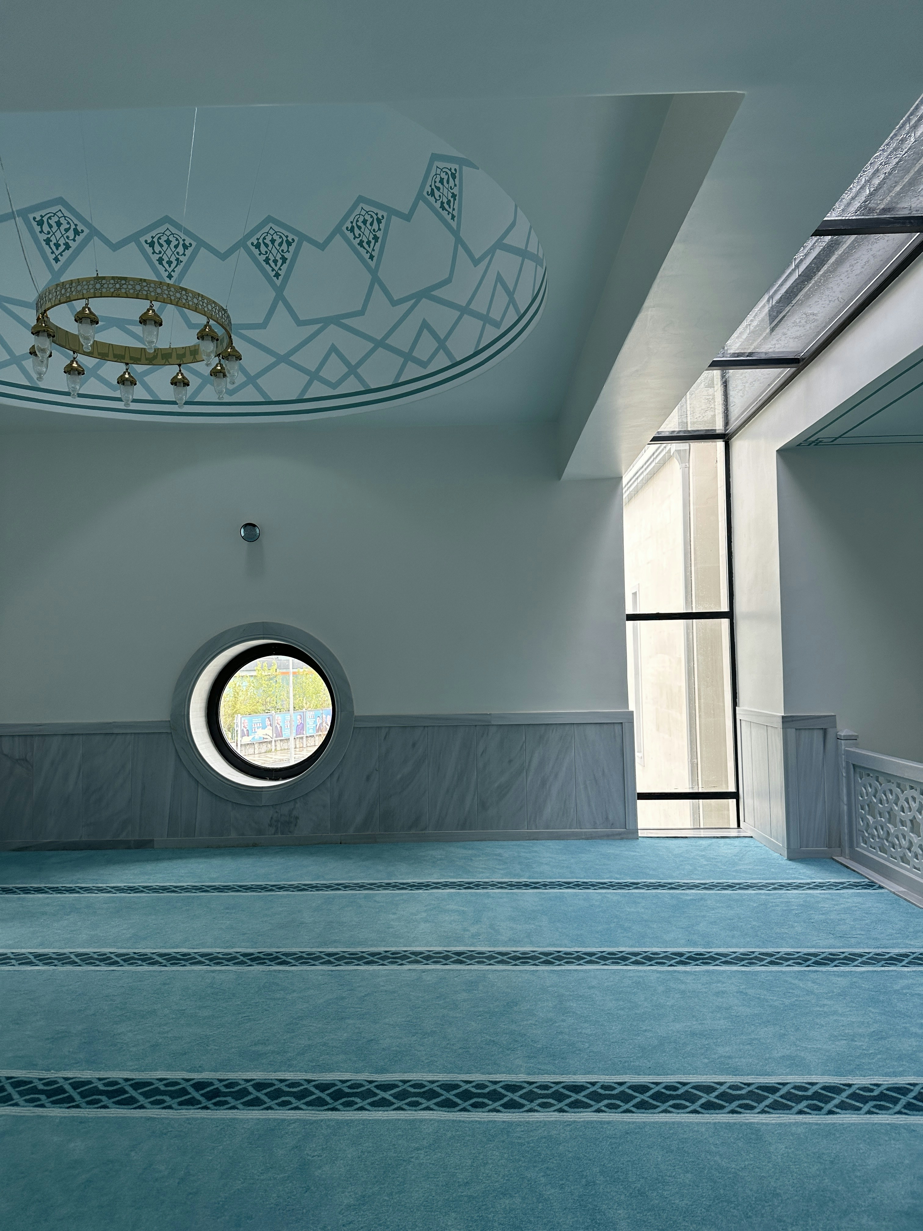 A large indoor swimming pool with a circular window photo – Free ...