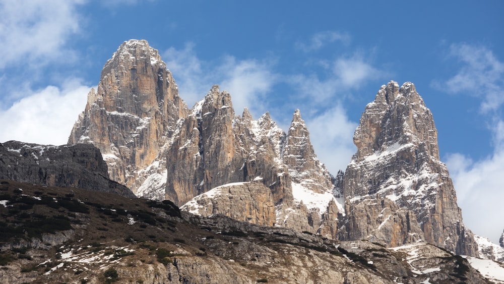 a mountain range with snow covered mountains in the background