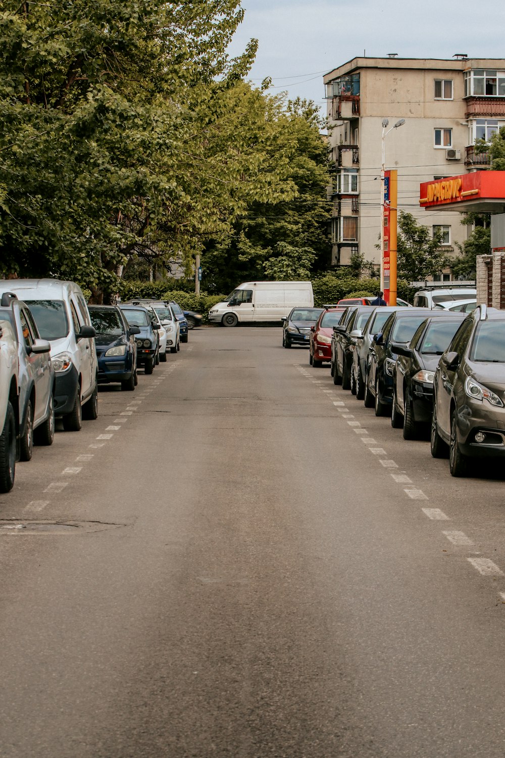 a row of parked cars on the side of a road