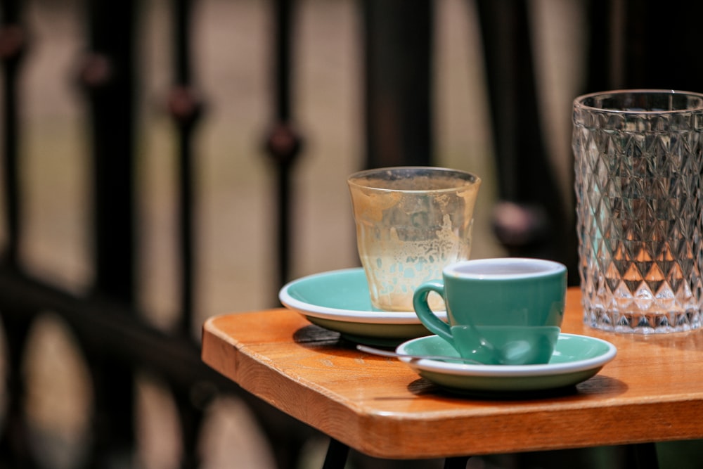 a couple of cups sitting on top of a wooden table