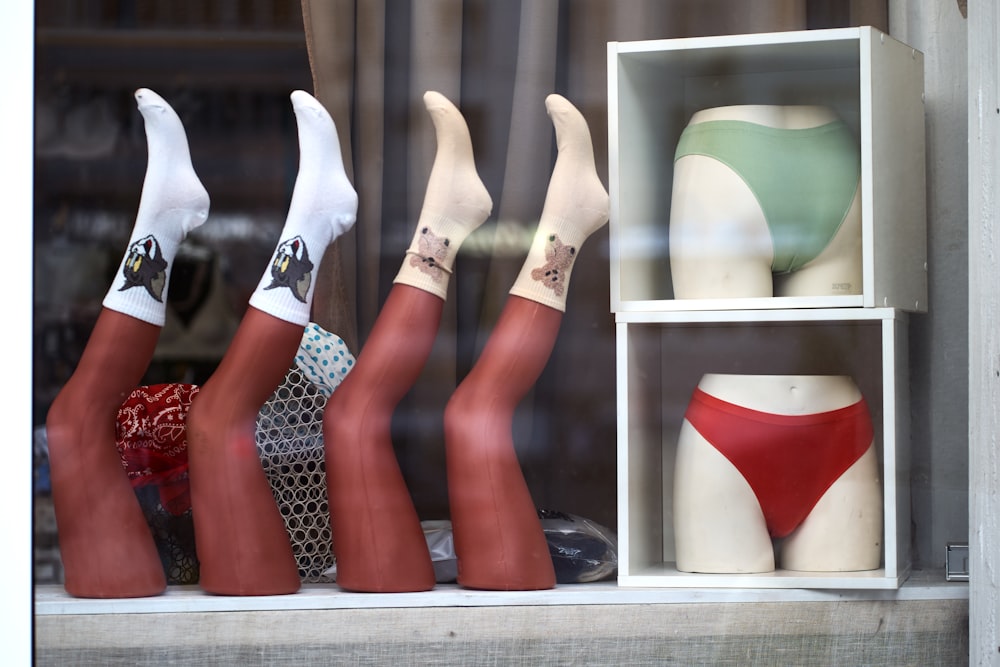 a window display with three mannequins in a display case