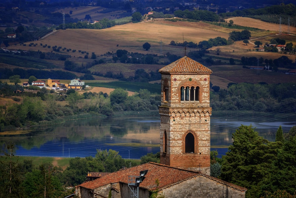 a church tower with a lake in the background