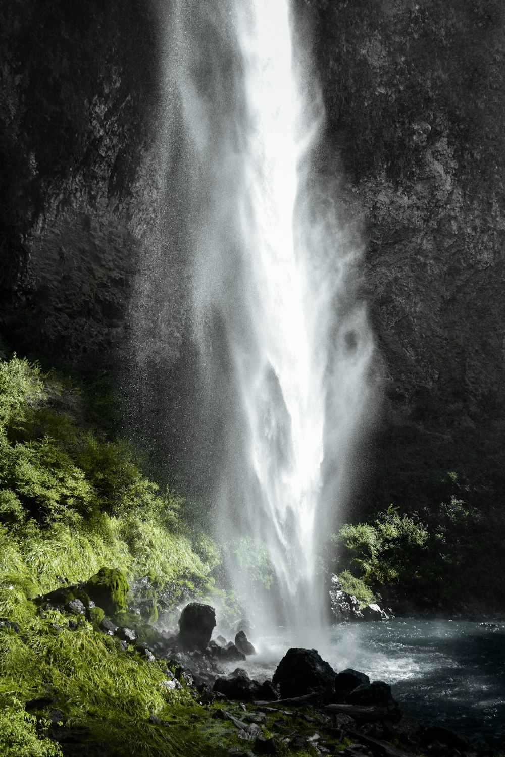 a large waterfall with water cascading down it's side