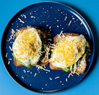 A cozy breakfast plate with scrambled eggs, avocado slices, and toast.