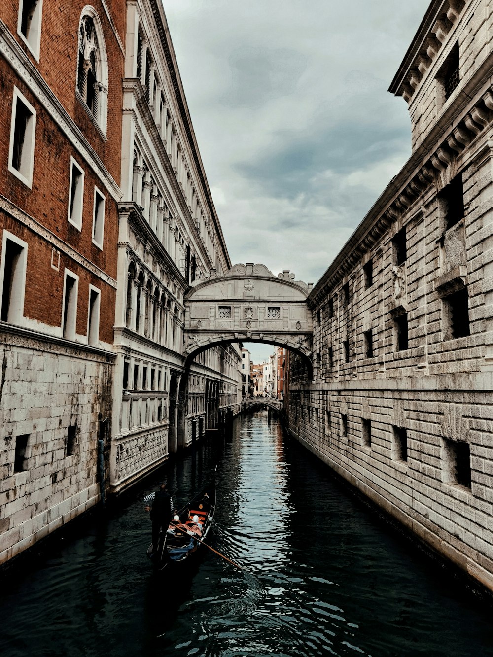 a boat is going down a narrow canal