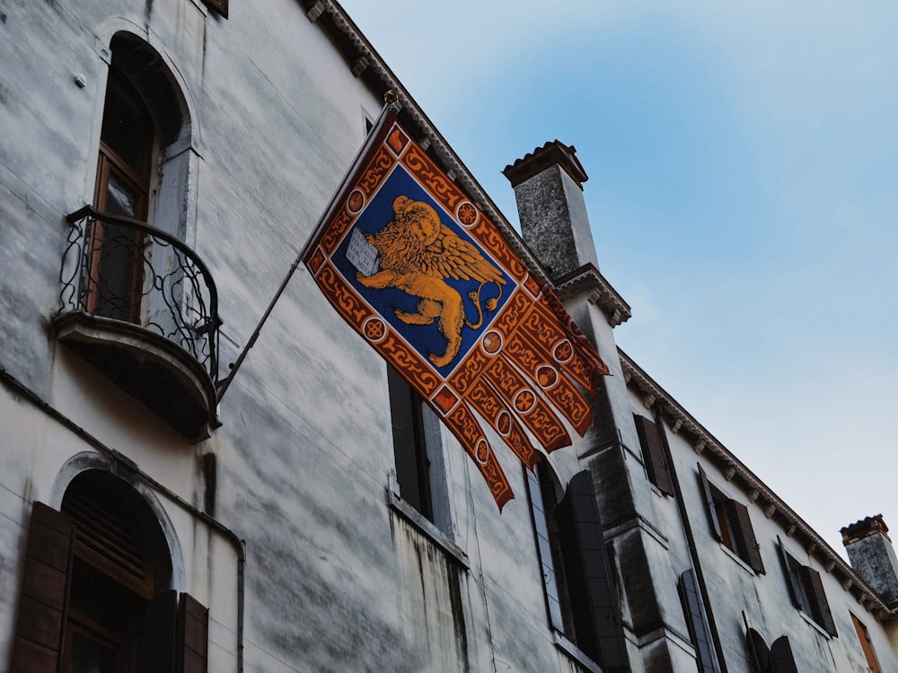 a building with a flag hanging from the side of it