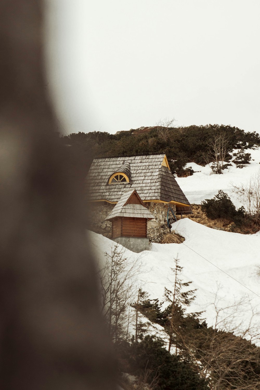 a house on a hill covered in snow