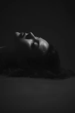 Elegant side profile of a woman showing lifted, glowing skin after HIFU therapy under soft lighting.
