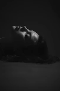 Elegant side profile of a woman showing lifted, glowing skin after HIFU therapy under soft lighting.