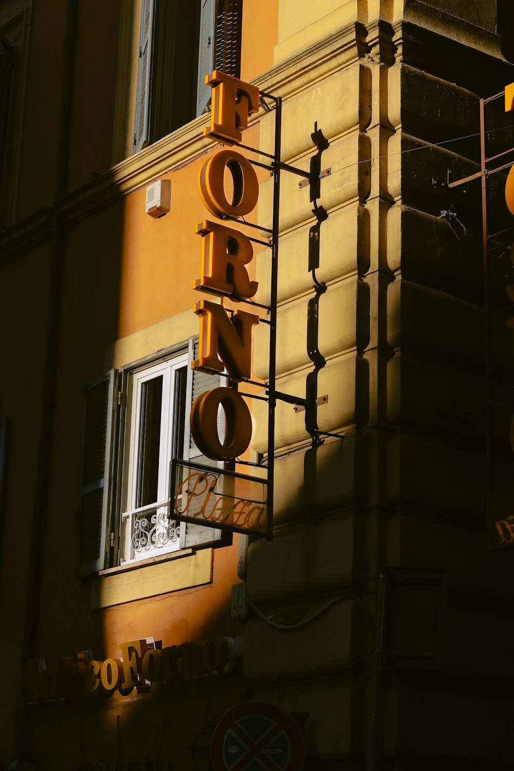 a yellow building with a sign that says hotel