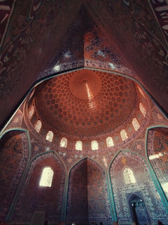 the ceiling of a large building with many windows