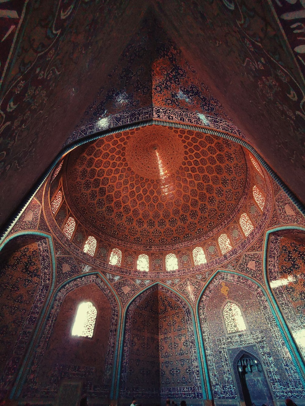 the ceiling of a large building with many windows