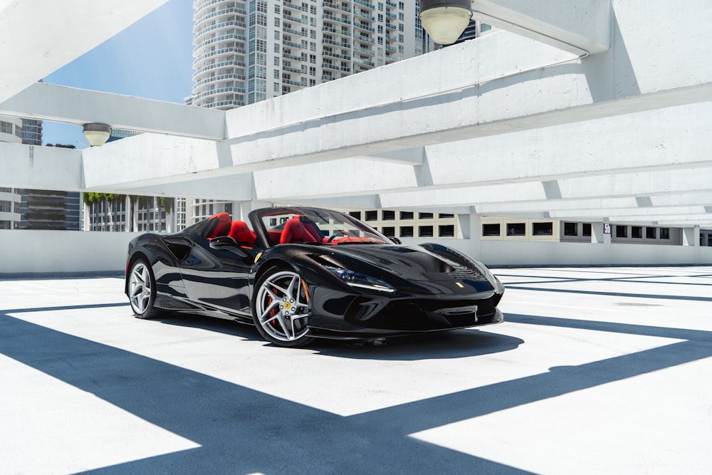 a black sports car parked in a parking lot