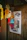Close-up of a colorful printed poster hanging on a wall with a cozy room background