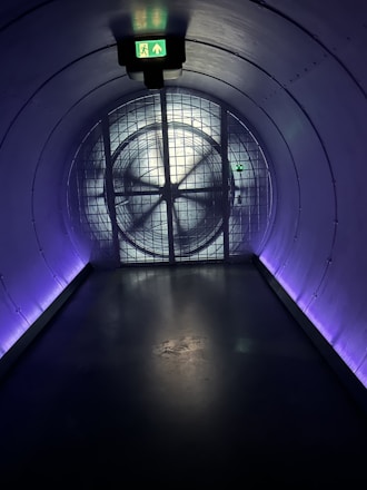 a tunnel with a clock on the wall