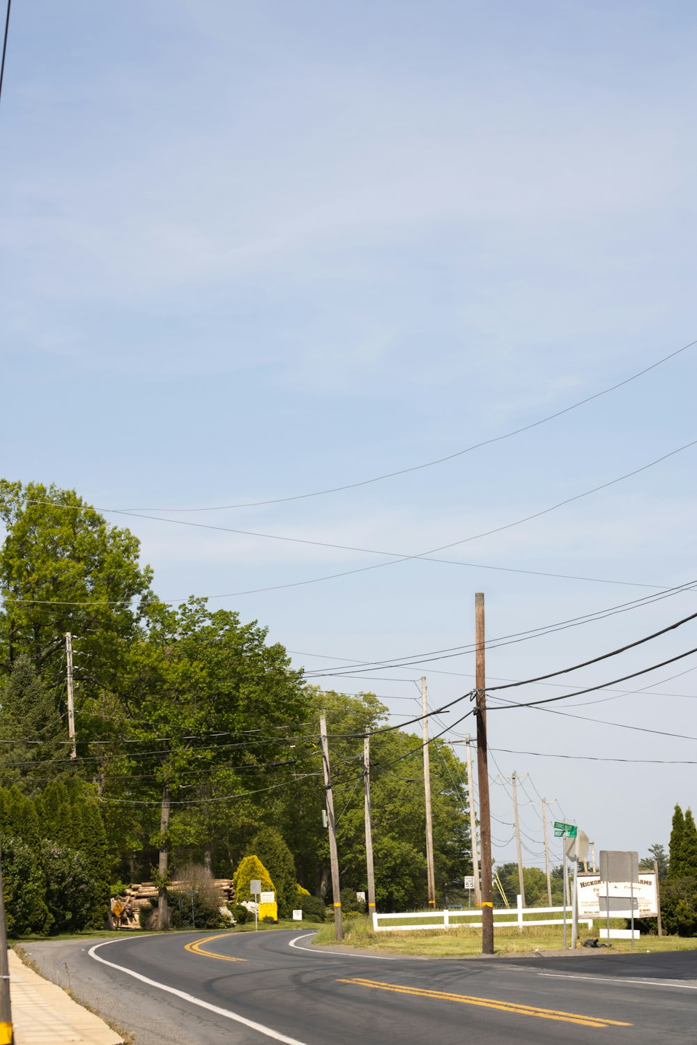 an empty street with power lines above it