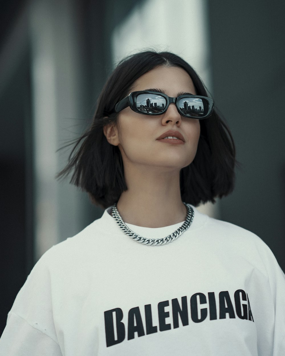 a woman wearing sunglasses and a t - shirt